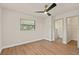 A bright bedroom features wood floors, a large window, and access to the bathroom at 5326 Weirwood Ave, Orlando, FL 32810