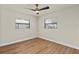 A bright bedroom features wood floors, large windows, and a modern ceiling fan at 5326 Weirwood Ave, Orlando, FL 32810