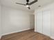 Bedroom boasts a modern ceiling fan, hardwood floors, and double door closet at 5326 Weirwood Ave, Orlando, FL 32810