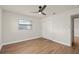 Bedroom featuring hardwood floors, a window providing natural light, and a closet at 5326 Weirwood Ave, Orlando, FL 32810