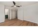 Bedroom featuring wood floors, ceiling fan, with doorways to the bathroom and closet at 5326 Weirwood Ave, Orlando, FL 32810