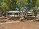 Charming single-story home featuring lush mature trees and a metal roof at 5326 Weirwood Ave, Orlando, FL 32810