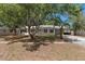 Charming single-story home featuring lush mature trees and a metal roof at 5326 Weirwood Ave, Orlando, FL 32810