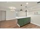 Kitchen island with stainless steel sink and appliances adjacent to the dining room at 5326 Weirwood Ave, Orlando, FL 32810