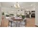 Bright living room features modern lighting, stainless appliances, and an island overlooking the dining area at 5326 Weirwood Ave, Orlando, FL 32810