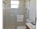 Bathroom with tiled shower featuring a sliding door, toilet, and a sink at 5502 Minaret Ct, Orlando, FL 32821