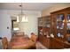 Dining room featuring a wooden table, chairs, and a glass-front display cabinet at 5502 Minaret Ct, Orlando, FL 32821