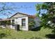 Exterior of the property with a white stucco wall and well-maintained green lawn at 5502 Minaret Ct, Orlando, FL 32821