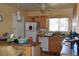 Functional kitchen with wooden cabinets, a white refrigerator, and a breakfast bar at 5502 Minaret Ct, Orlando, FL 32821