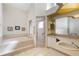 Bathroom featuring a tiled soaking tub with tile surround, shower, and vanity with double sinks at 58 Golf View Dr, Ocala, FL 34472