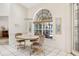 Bright breakfast nook featuring a large arched window and comfortable seating at 58 Golf View Dr, Ocala, FL 34472