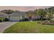 Well-maintained front yard featuring a landscaped lawn, palm tree, and a beautiful front door at 58 Golf View Dr, Ocala, FL 34472