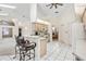 Open kitchen with a breakfast bar, white cabinets, and tile flooring at 58 Golf View Dr, Ocala, FL 34472