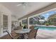 Covered lanai featuring a dining table and view of the screened in pool and patio at 58 Golf View Dr, Ocala, FL 34472