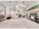 Expansive living room with a ceiling fan, high ceilings, and sliding glass doors to the outdoors at 58 Golf View Dr, Ocala, FL 34472