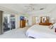 Bright main bedroom with tray ceiling, neutral carpet, access to lanai, and ensuite bathroom at 58 Golf View Dr, Ocala, FL 34472