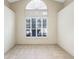 Bright, carpeted room with a large window at 58 Golf View Dr, Ocala, FL 34472