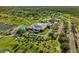Aerial view of a community clubhouse with a pool, tennis courts, and ample parking surrounded by greenery at 6147 Sunnyvale Dr # Ge, Orlando, FL 32822