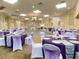 Elegantly decorated ballroom with tables set for a special event, featuring violet and silver decor at 6147 Sunnyvale Dr # Ge, Orlando, FL 32822