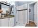 Modern bathroom with a glass enclosed shower, updated fixtures, vanity with sink, and tiled floors at 6147 Sunnyvale Dr # Ge, Orlando, FL 32822