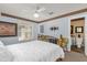 Bedroom featuring a ceiling fan and an ensuite bathroom with a toilet and brown tiled floor at 6147 Sunnyvale Dr # Ge, Orlando, FL 32822