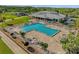 Aerial view of a large community pool with lounge chairs, umbrellas, and mature palm trees at 6147 Sunnyvale Dr # Ge, Orlando, FL 32822