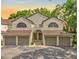 Inviting townhome with arched entry, multiple garages and lush landscaping for enhanced curb appeal at 6147 Sunnyvale Dr # Ge, Orlando, FL 32822