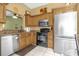 Functional kitchen space with wood cabinets, granite counters and stainless steel appliances with eat in nook at 6147 Sunnyvale Dr # Ge, Orlando, FL 32822