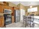 Efficient kitchen with stainless steel appliances, warm cabinetry and adjacent breakfast nook for dining at 6147 Sunnyvale Dr # Ge, Orlando, FL 32822