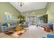 Bright living room with high ceilings, a sliding door, and a decorative fireplace at 6147 Sunnyvale Dr # Ge, Orlando, FL 32822