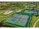 Aerial view of well-maintained tennis and basketball courts, playground, and golf course in a vibrant community at 6147 Sunnyvale Dr # Ge, Orlando, FL 32822