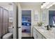 The bathroom features a granite countertop, white cabinets, and a view into the Frozen-themed bedroom at 634 Chadbury Way, Kissimmee, FL 34744
