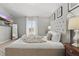 Bright bedroom with a large bed, a full-length mirror, and an exterior view at 634 Chadbury Way, Kissimmee, FL 34744