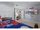 Whimsical bedroom features a super hero theme, closet, and a boat scene on TV screen at 634 Chadbury Way, Kissimmee, FL 34744