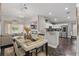 Open-concept dining area adjacent to kitchen and living room, featuring modern decor and ample natural light at 634 Chadbury Way, Kissimmee, FL 34744