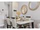 Dining room with white table and modern decor, complemented by stylish mirrors and elegant seating at 634 Chadbury Way, Kissimmee, FL 34744