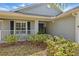 View of the front porch and door area with well-maintained landscaping at 634 Chadbury Way, Kissimmee, FL 34744