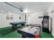 Spacious game room with a pool table, an air hockey table, and fun arcade games at 634 Chadbury Way, Kissimmee, FL 34744