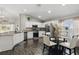 Modern kitchen with white cabinets, granite countertops, stainless steel appliances, and dark wood flooring at 634 Chadbury Way, Kissimmee, FL 34744