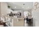Bright kitchen featuring white cabinetry, stainless steel appliances, granite counters, and bar stool seating at 634 Chadbury Way, Kissimmee, FL 34744