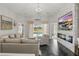 Open living room with modern fireplace, neutral decor, large windows with pool view, and stylish furnishings at 634 Chadbury Way, Kissimmee, FL 34744
