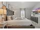 Spacious bedroom with an upholstered headboard, complemented by decorative pillows and a serene ambiance at 634 Chadbury Way, Kissimmee, FL 34744