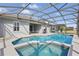 Home exterior showcasing a screened-in pool and patio with a built-in spa at 634 Chadbury Way, Kissimmee, FL 34744