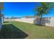 Fenced backyard showing a large grassy area and privacy fence for seclusion at 690 Blue Citrus Ln, Minneola, FL 34715