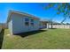 View of the backyard with a covered patio and well-maintained lawn at 690 Blue Citrus Ln, Minneola, FL 34715