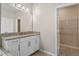 Bathroom vanity with granite countertop adjacent to closet with wire shelving at 690 Blue Citrus Ln, Minneola, FL 34715