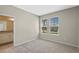 Bedroom featuring neutral carpet, two windows, and ensuite bathroom at 690 Blue Citrus Ln, Minneola, FL 34715
