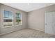 Well-lit bedroom with plush carpet, two windows, and neutral walls at 690 Blue Citrus Ln, Minneola, FL 34715