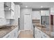 This kitchen features stainless steel appliances, a gas range, and a spacious island at 690 Blue Citrus Ln, Minneola, FL 34715