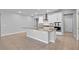 The kitchen features a large island, stainless appliances, and ample lighting at 690 Blue Citrus Ln, Minneola, FL 34715